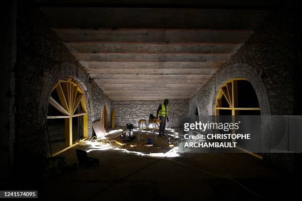 Worker performs restoration work in the basement of the under-restoration Grand Palais in Paris on June 27, 2022.