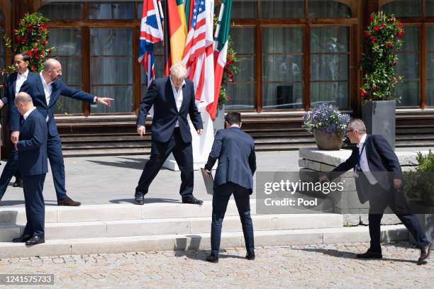 President of the European Council Charles Michel helps direct Prime Minister Boris Johnson, to his spot for the extended family photo of leaders from...