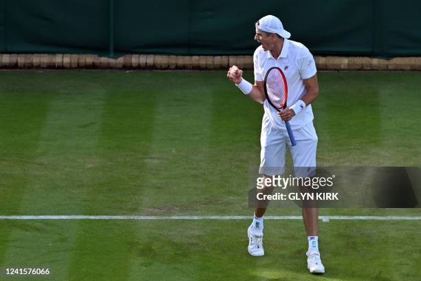 Player John Isner celebrates winning the match point during his men's singles tennis match against France's Enzo Couacaud on the first day of the...