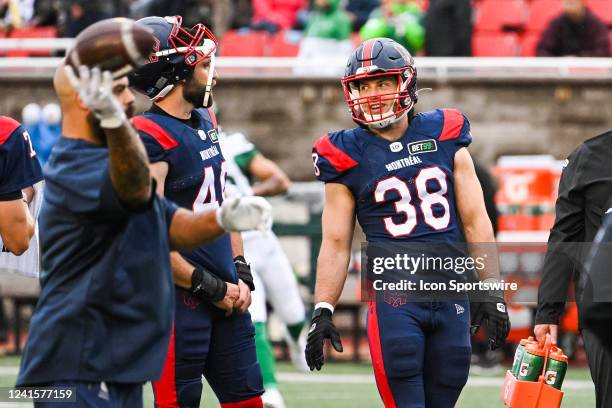 Montreal Alouettes fullback Christophe Normand discusses with a teammate at warm-up before the Saskatchewan Roughriders versus the Montreal Alouettes...