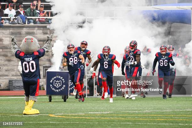 Montreal Alouettes players run on the field before the Saskatchewan Roughriders versus the Montreal Alouettes game on June 23 at Percival Molson...