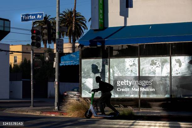 Man rides a scooter along Fairfax Ave. Between Melrose Ave. And Beverly Blvd., the real-life setting that inspired Amazons animated series Fairfax.
