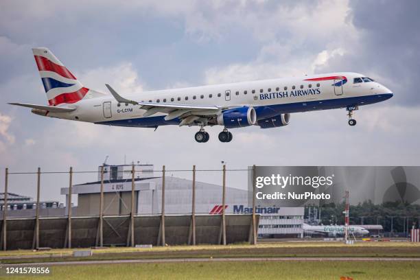 British Airways Embraer ERJ-190 aircraft as seen flying and landing at Amsterdam Schiphol Airport. The narrow-body airplane has the registration...