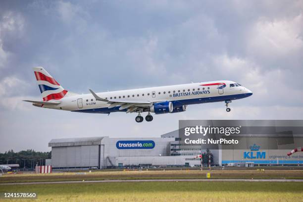 British Airways Embraer ERJ-190 aircraft as seen flying and landing at Amsterdam Schiphol Airport. The narrow-body airplane has the registration...