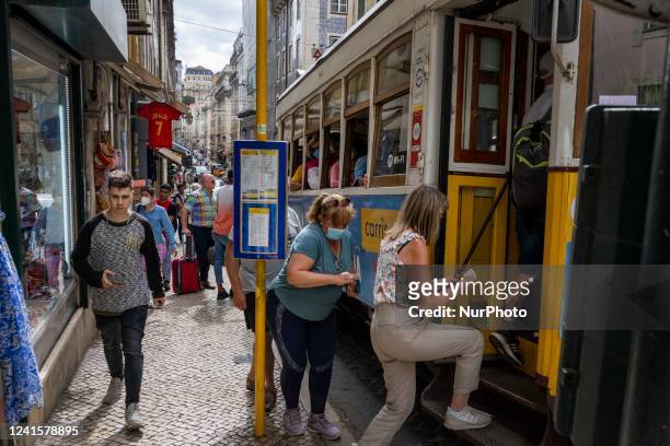 People are seen boarding a tram in the Baixa district. Lisbon, June 24, 2022. In Portugal, covid-19 mortality is declining, although it is still more...
