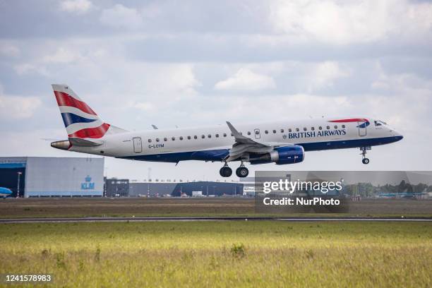 British Airways Embraer ERJ-190 aircraft as seen flying and landing at Amsterdam Schiphol Airport. The narrow-body airplane has the registration...