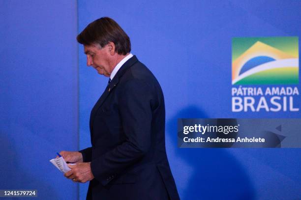 President of Brazil Jair Bolsonaro looks on during the ceremony to unveil a project for new national ID's and passports at Planalto Palace on June...