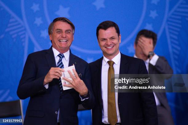 Justice Minister Anderson Gustavo Torres hands over a new passport to President of Brazil Jair Bolsonaro during the ceremony to unveil a project for...