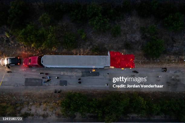 In this aerial view, members of law enforcement investigate a tractor trailer on June 27, 2022 in San Antonio, Texas. According to reports, at least...