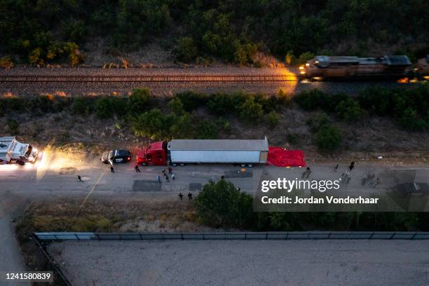 In this aerial view, members of law enforcement investigate a tractor trailer on June 27, 2022 in San Antonio, Texas. According to reports, at least...