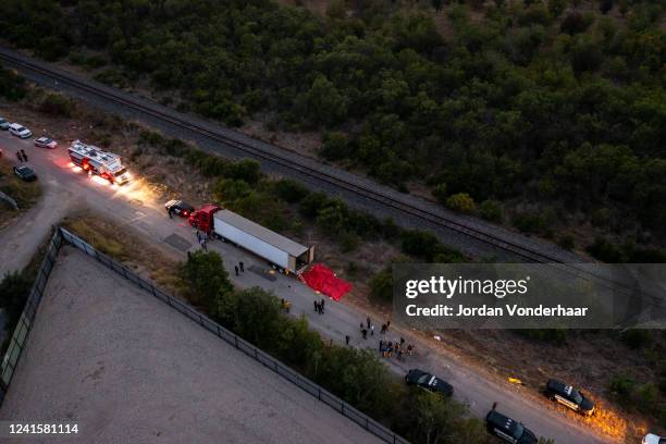In this aerial view, members of law enforcement investigate a tractor trailer on June 27, 2022 in San Antonio, Texas. According to reports, at least...