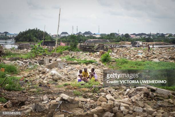 Children play between demolished structures as their parents are at work in Elechi, Port Harcourt, Nigeria, on March 10, 2022. Port Harcourt's...