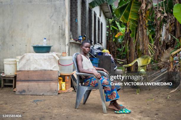 Mother sits in the abandoned government compound, keeping one watchful eye on her children and the other on her only belongings, in Diobu, Port...