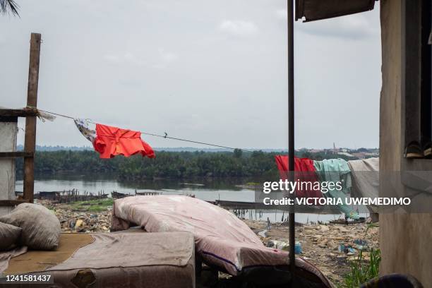 General view of mattresses and clothes salvaged from the demolished community are laid out to dry in the upland area of Diobu, Port Harcourt,...