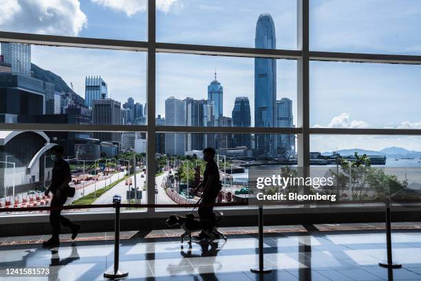 Law enforcement officers walk with a bomb sniffing dog at the Hong Kong Convention and Exhibition Center in Hong Kong, China, on Monday, June 27,...