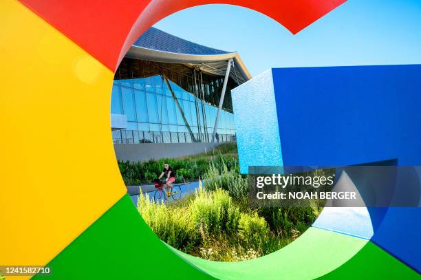 Bicyclist rides along a path at Google's Bay View campus in Mountain View, California on June 27, 2022.