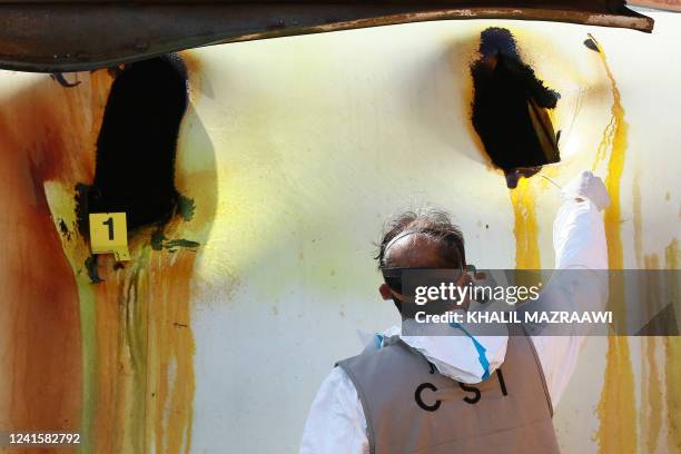 Jordanian forensics expert inspects the site of a toxic gas explosion in the Red Sea port of Aqaba on June 28, 2022. - A chlorine gas explosion...