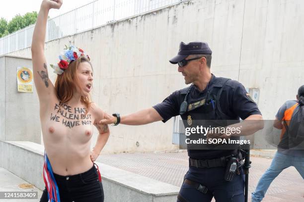 Spanish police remove a FEMEN activist protesting outside the US Embassy against the US Supreme Court decision to overturn abortion rights. The...