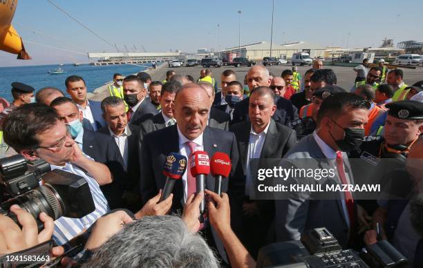 Jordanian Prime Minister Bisher al-Khasawneh talks to reporters as he visits the site of a toxic gas explosion in the Red Sea port of Aqaba on June...