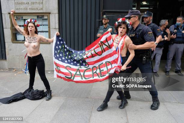 Spanish police remove two FEMEN activists protesting outside the US Embassy against the US Supreme Court decision to overturn abortion rights. The...