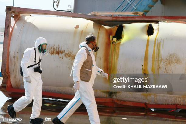 Jordanian forensics experts inspect the site of a toxic gas explosion in the Red Sea port of Aqaba on June 28, 2022. - A chlorine gas explosion...