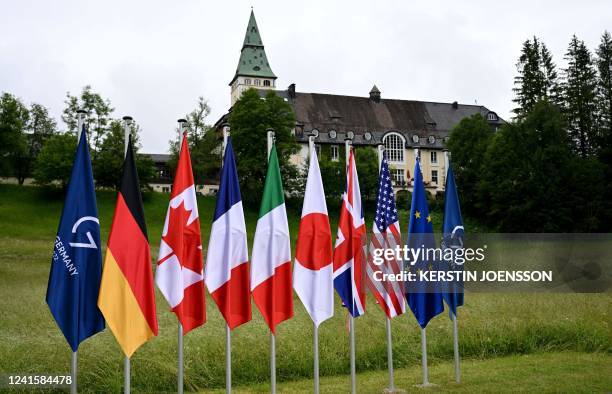 The flags of the G7 countries, the European Union and the 2022 G7 summit are seen on June 28, 2022 in front of Elmau Castle, southern Germany, prior...