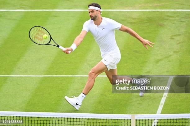 Bulgaria's Grigor Dimitrov returns the ball to US player Steve Johnson during their men's singles tennis match on the second day of the 2022...