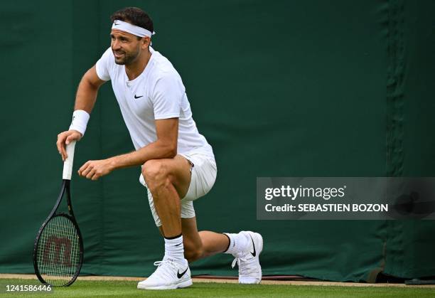 Bulgaria's Grigor Dimitrov reacts as he plays against US player Steve Johnson during their men's singles tennis match, due to an injury, on the...