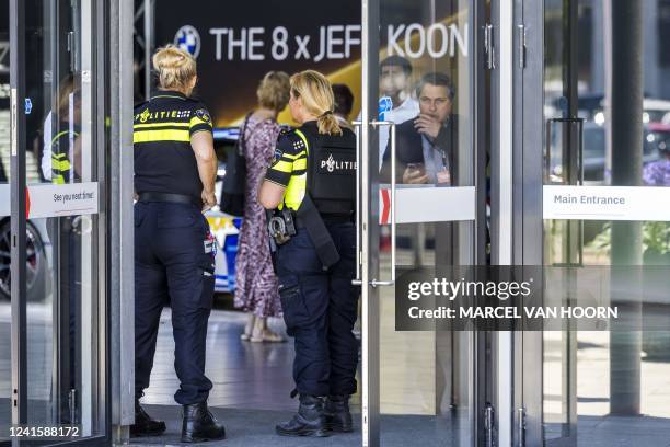 Dutch police officers stand guard at the entrance of the TEFAF Art Fair in Maastricht on June 28 following a robbery. - Armed robbers raided the...