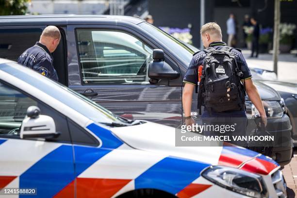 Dutch police officers stand guard near the entrance of the TEFAF Art Fair in Maastricht on June 28 following a robbery. - Armed robbers raided the...