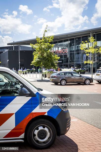 This photograph taken on June 28 shows a Dutch police car in front of the TEFAF art fair in Maastricht, following a robbery. - Armed robbers raided...