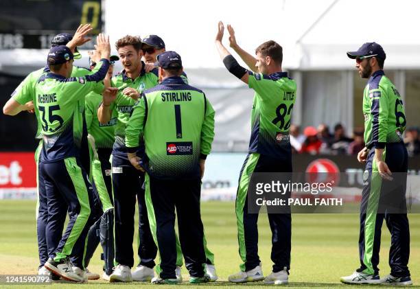 Ireland's Andy McBrine celebrates with teammateas after they took the wicket of India's Ishan Kishan during the second Twenty20 International cricket...