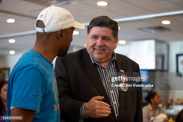 Illinois Governor J.B. Pritzker speaks to a supporter on Primary Day at Manny's Deli on June 28, 2022 in Chicago, Illinois. Voters will be deciding...