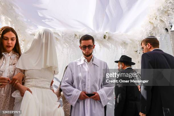 Bride Elisheva Chaya and the groom Gabriel Grigoriev under the Chuppah during a Jewish marriage ceremony held by Chabad Berlin for two Jewish...