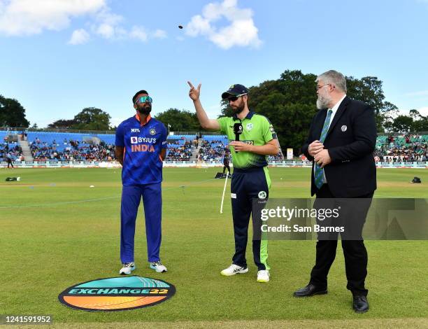 Dublin , Ireland - 28 June 2022; Andrew Balbirnie of Ireland, centre, makes the toss watched by Hardik Pandya of India, left, and match referee Kevin...