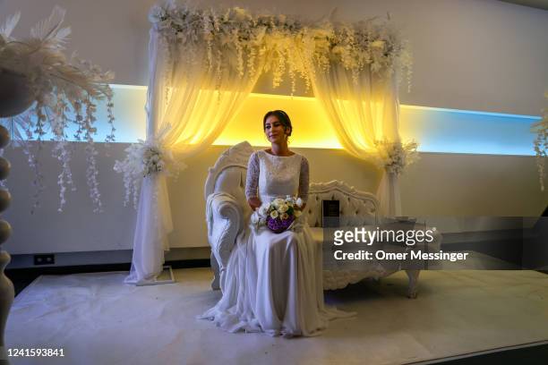 Bride Elisheva Chayaa sits on the bride honor chair before a Jewish marriage ceremony held by Chabad Berlin for two Jewish Ukrainian refugees from...