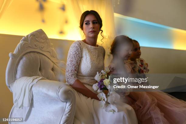 Bride Elisheva Chayaa sits on the bride honor chair before a Jewish marriage ceremony held by Chabad Berlin for two Jewish Ukrainian refugees from...