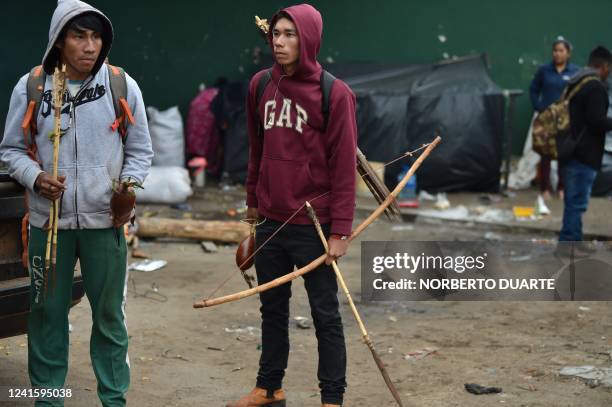 Indigenous men are seen with bows and arrows outside the National Institute of the Indigenous as they protest demanding the government for basic food...