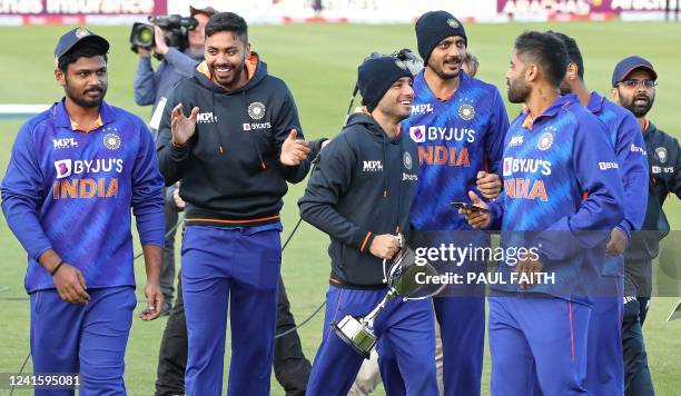 Members of India's team react with the trophy after winning the second Twenty20 International cricket match between Ireland and India at Malahide...