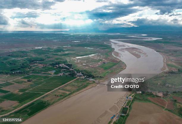 Aerial photo taken on June 28, 2022 shows the scenery of jinjin Ferry in the Yellow River in Baotou, Inner Mongolia, China. Jinjin ferry is an...