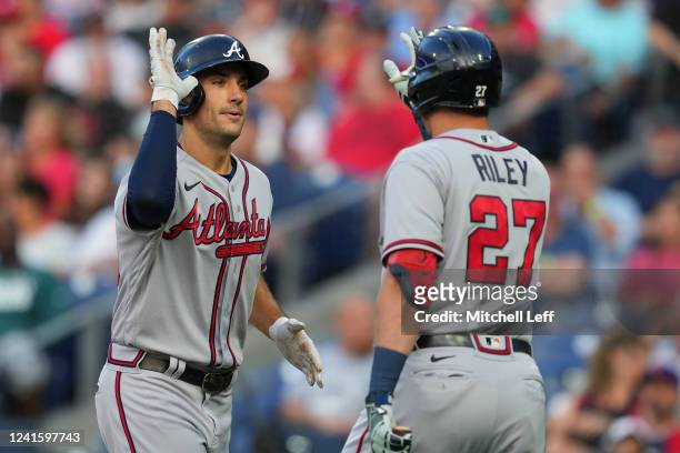 Matt Olson of the Atlanta Braves high fives Austin Riley after hitting a solo home run in the top of the first inning against the Philadelphia...