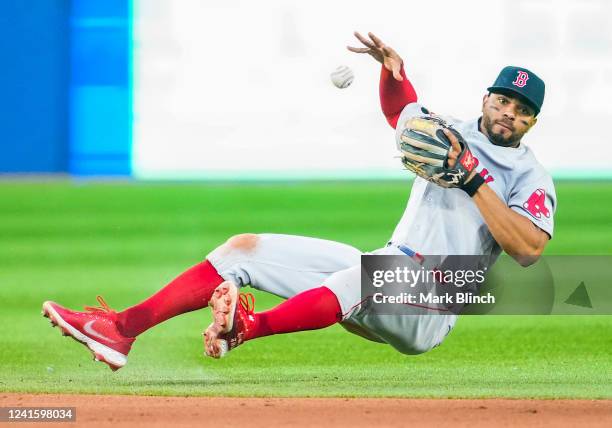 Xander Bogaerts of the Boston Red Sox makes a stop on a ground ball but couldn't make the throw to first base against the Toronto Blue Jays in the...