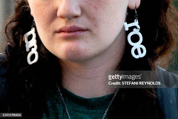 An abortion rights activist wears "Pro Roe" earrings outside the US Supreme Court in Washington, DC, on June 28, 2022. The US Supreme Court on June...