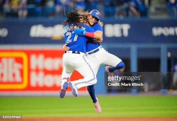 Vladimir Guerrero Jr. #27 of the Toronto Blue Jays celebrates his walk off single in the ninth inning with Bo Bichette to defeat the Boston Red Sox...