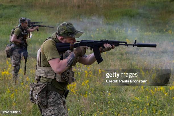 Azov Regiment soldiers fire weapons during target practice on June 28, 2022 in the Kharkiv region, Ukraine.The Azov Regiment was founded as a...