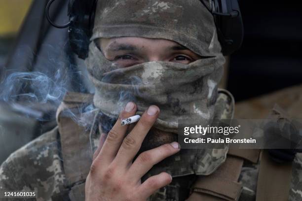 An Azov Regiment soldier smokes a cigarette during tactical training on June 28, 2022 in the Kharkiv region, Ukraine.The Azov Regiment was founded as...