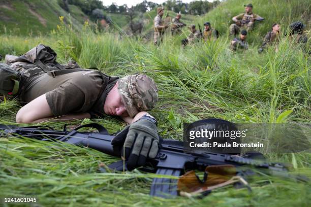 Soldier rests in the field during tactical gun practice on June 28, 2022 in the Kharkiv region, Ukraine.The Azov Regiment was founded as a...