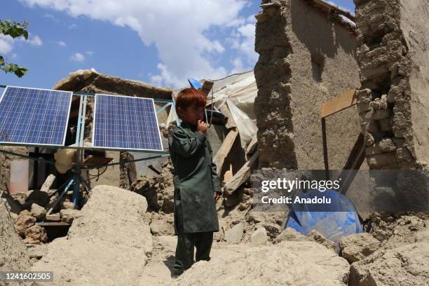 Child is seen in front of collapsed house on June 27, 2022 as earthquake victims wait for more humanitarian aid such as food, tents and blankets...