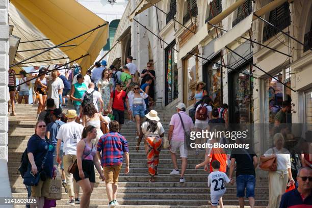 Tourists pass shops lining the Rialto Bridge in Venice, Italy, on Wednesday, June 15, 2022. As the world emerges from two years of pandemic...
