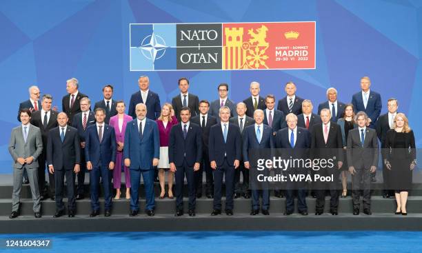 Prime Minister Boris Johnson stands beside US President Joe Biden and other world leaders posing for the family photo during the Nato summit on June...